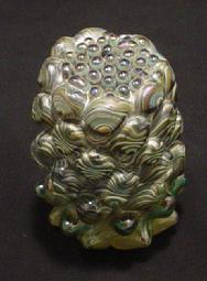 Blown glass: Small reduction paperweights, optic molded and snipped with shears, then melted down to round off the piece.