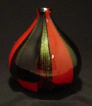 This vase is made of red & black sheet glass and golden dichroic strips, approximately 12"
