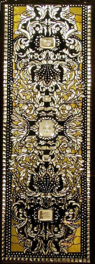 The design in this window is very complex. There are over 1000 bevels and over 1000 jewels in this piece. It measures approximately 2'x6' and is called Baroque Banquet.