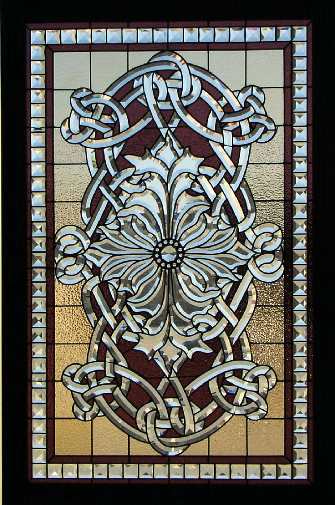 This window is called the Sullivan Window. This design is based off a L. Sullivan design. Beveled glass contributes to most of this window. It also incorporates some stained glass as well as a few jewels. The bevels in this window are hand cut and beveled by Bogenrief Studios. Each bevel goes through a five-stage process to create this exquisite look. Lead came is used in this window to create a more linear look. The bevels are made out of 5/16" starfire plate glass.